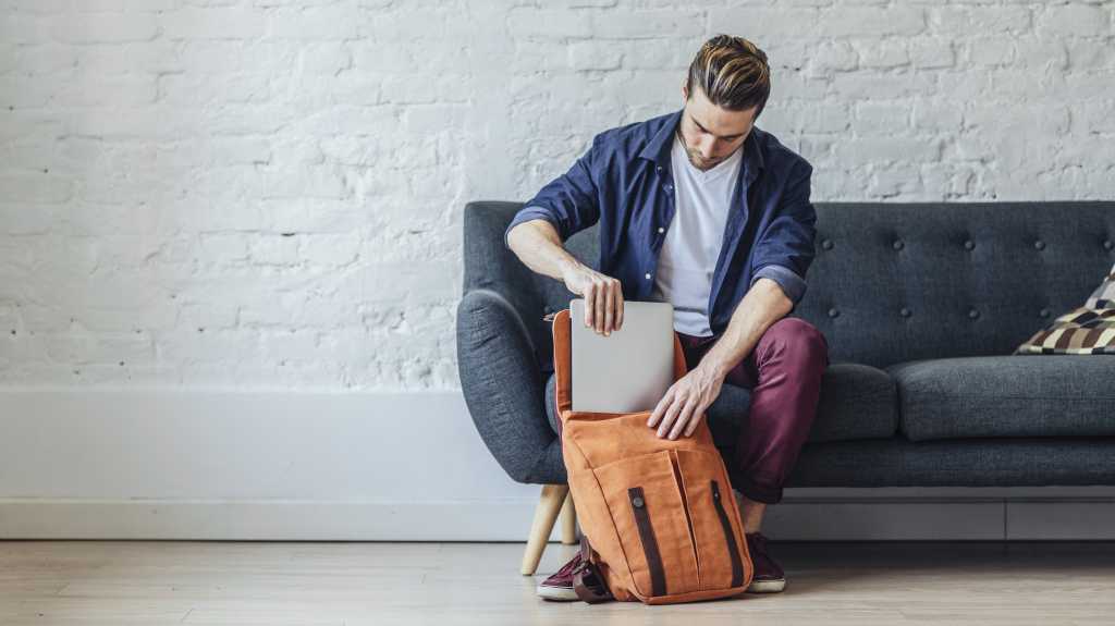 putting laptop into backpack